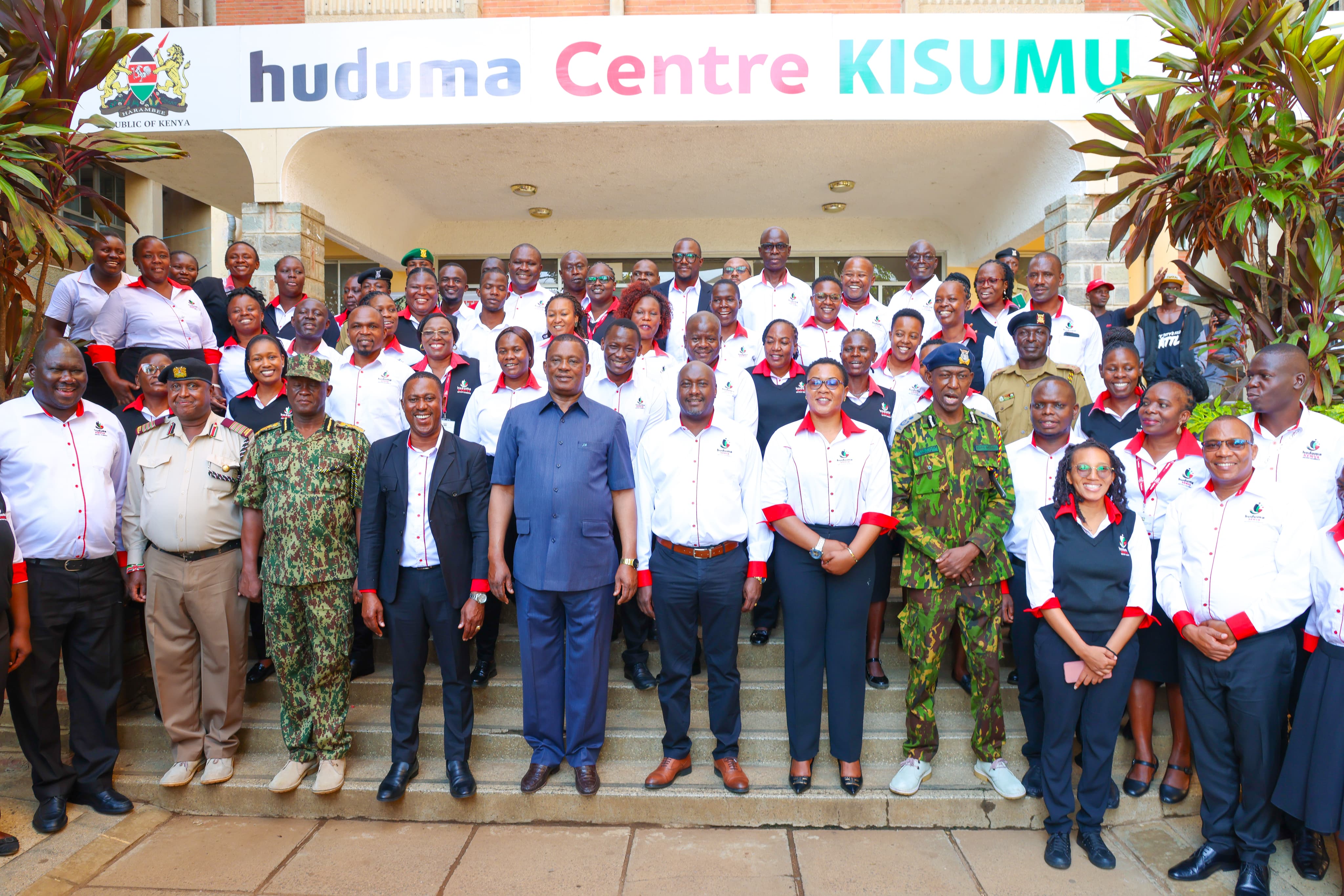 CS in a group Photo with Huduma Staff Kisumu County